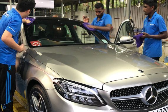 Professional auto detailing technicians at Taiyo CarePoint servicing a Mercedez Benz